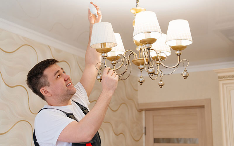 electrician struggling with a lighbulb